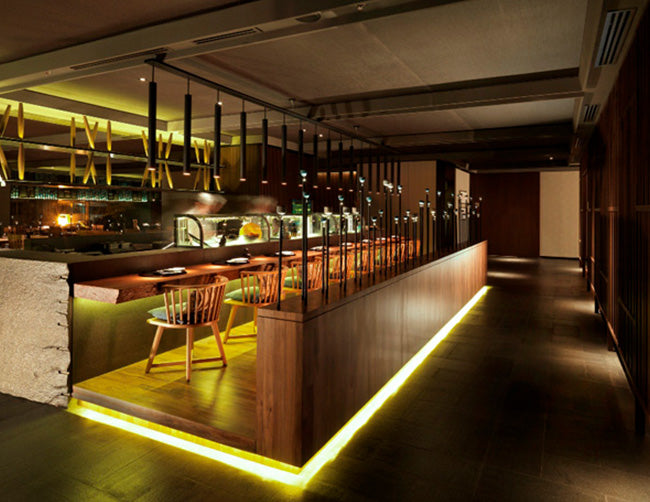 A restaurant bar is decorated with RGB LED strip lights that are powered by a dimmable low voltage transformer.