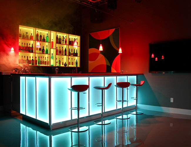 A bar is decorated with RGB LED strip lights that are powered by a dimmable low voltage transformer.