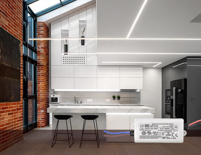 A modern kitchen is illuminated with LED strip lights, powered by low voltage transformers.