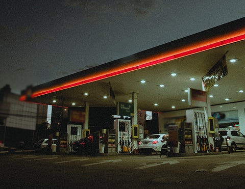 Many LED Gas Station Canopy Lights are illuminating a gas station.