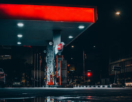Many LED Gas Station Canopy Lights are illuminating a gas station.