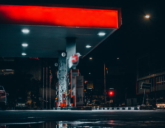 Many LED Gas Station Canopy Lights are illuminating a gas station.