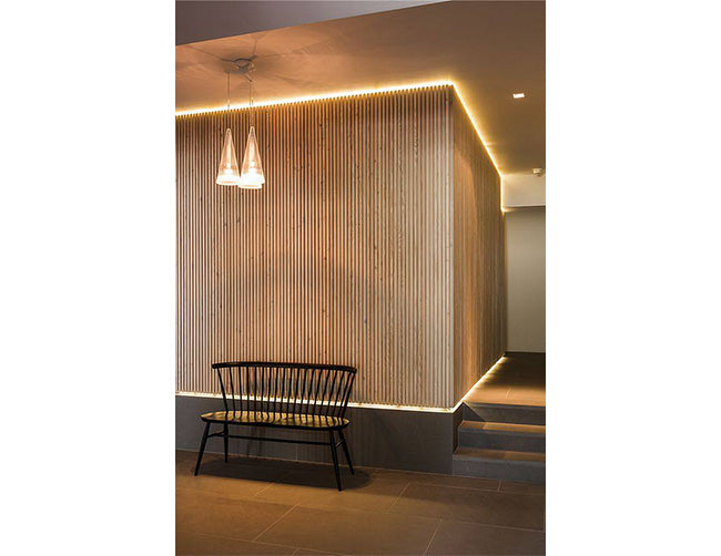 A modern lobby seating area is decorated with LED strip lights that are powered by a dimmable low voltage transformer.