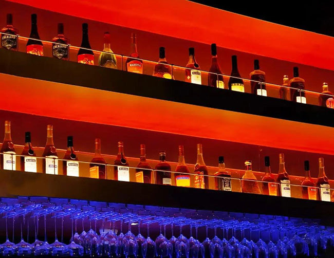 LED Strip Light - Color Changing - RGB - Super Bright - Wet/Damp Location IP65 - 24V is installed to illuminate a wine shelf in bar space.