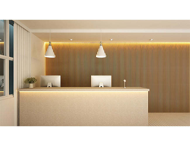 A hotel reception desk is decorated with LED strip lights that are powered by a dimmable LED low voltage transformer.