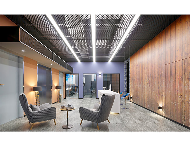 Extended ceiling recessed GL LED L8456 linear light fixtures illuminate an office lounge area.