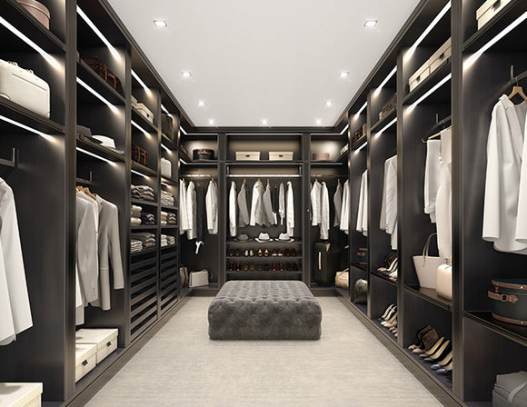 LED strip lights are used in an aluminum channel to illuminate a walk-in closet.