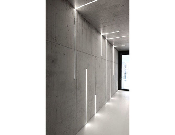 LED strip lights are used in an aluminum channel to illuminate a hallway.