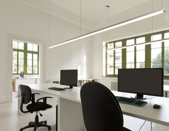 Suspended white color GL LED linear strip light fixture 8ft form long fixtures illuminating a computer lab.