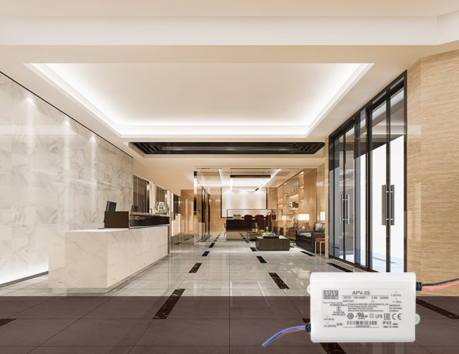 A modern and sleek hotel lobby decorated with LED lighting systems powered by low voltage drivers.