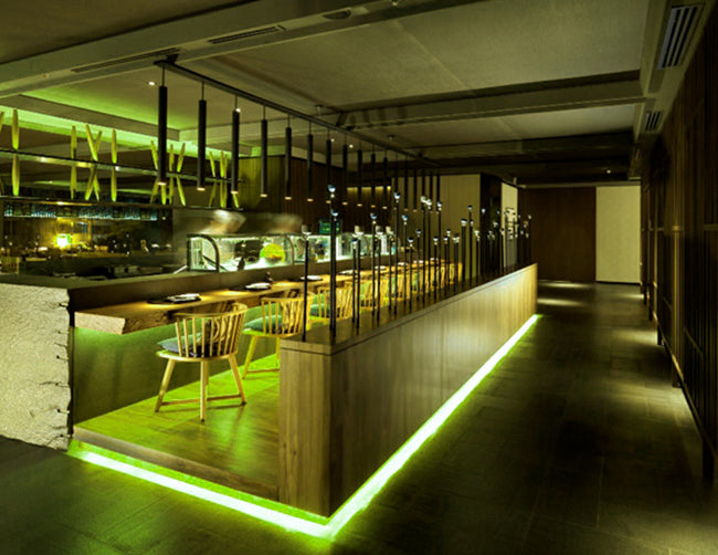 LED RGB strip lights installed at the bottom of bar cabinets illuminate down to floors.