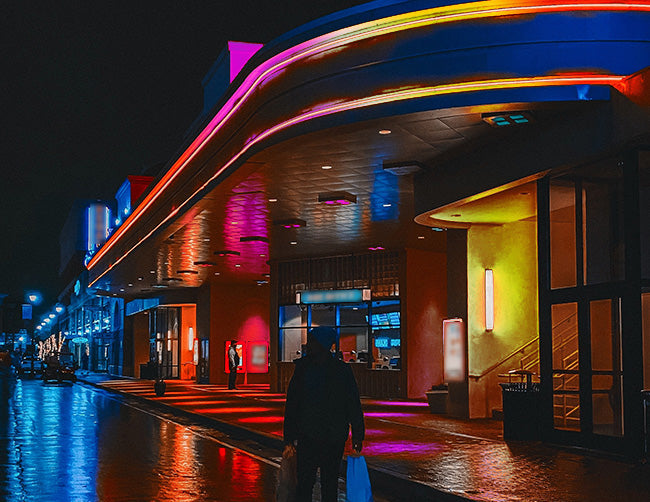 A building exterior is decorated with wet rated RGB LED strip lights that are powered by a dimmable low voltage transformer.