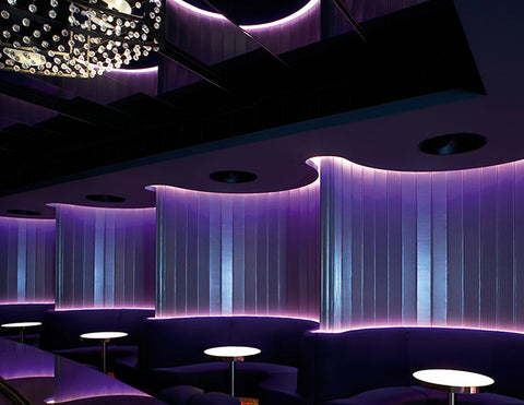 LED strip lights are used as cove lighting to illuminate a lounge area.