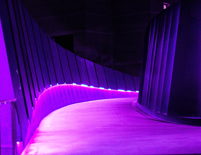 A hallway corridor is decorated with wet rated IP65 color changing RGB LED strip lights that are powered by a dimmable low voltage transformer.