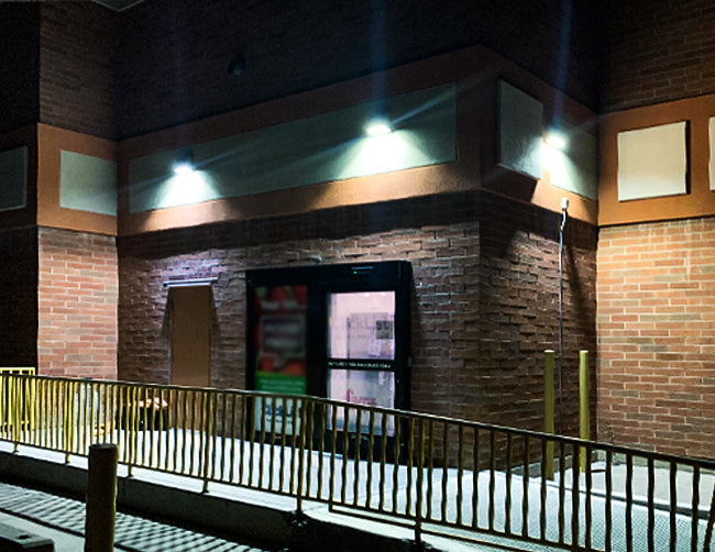 LED Full-Cutoff Wall Pack Light 70W installed and illuminating in an exterior of a building.