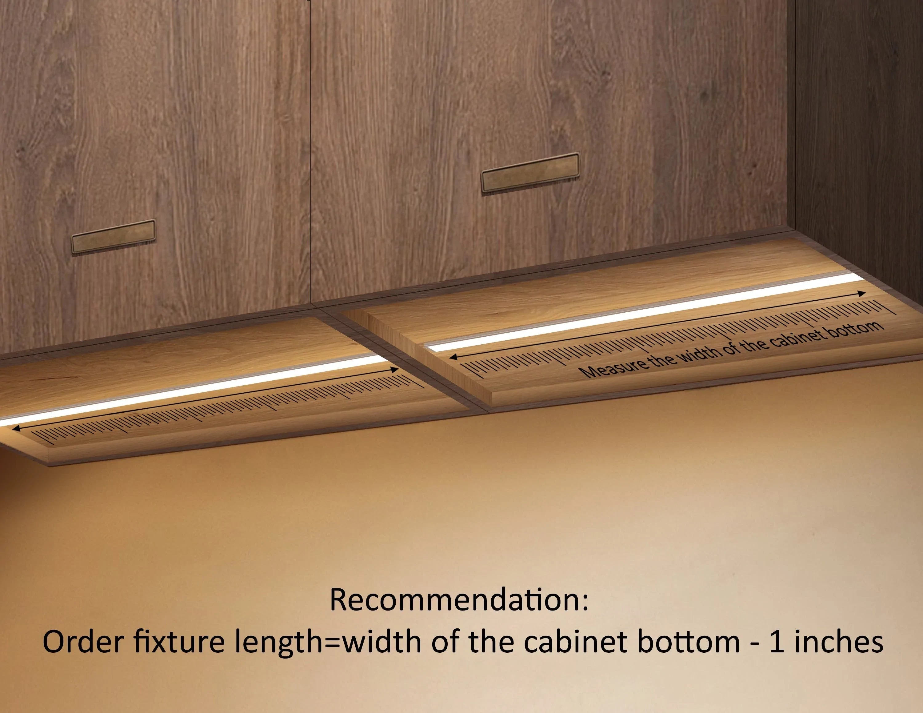 Two LED strip lights are installed under a cabinet and illuminating the space. Length scales are marked along the strip lights to indicate that the width of the cabinet bottom needs to be measured to match length of the strip light fixture. A separate note is shown at the bottom of the image saying "Recommendation: Order fixture length = width of the cabinet bottom - 1 inch".